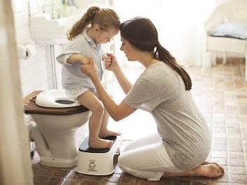 Parent supports child with toilet training